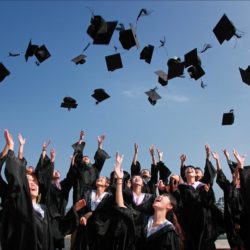 a picture of students celebrating without knowing the student loan debt burden ahead